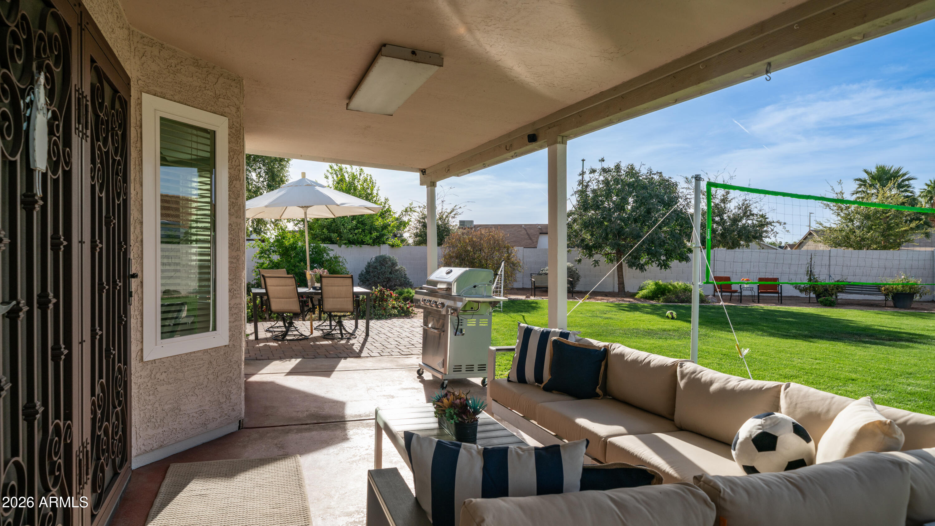 408 East Meadows Lane Gilbert, AZ 85234 - Photo 4 of 42 a view of a patio with couches potted plants and a big yard