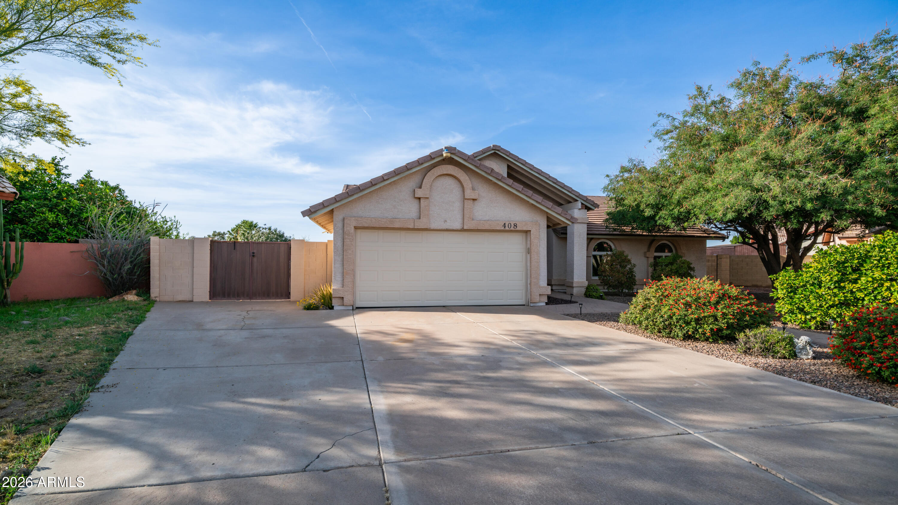 408 East Meadows Lane Gilbert, AZ 85234 - Photo 6 of 42 a front view of a house with a yard and garage
