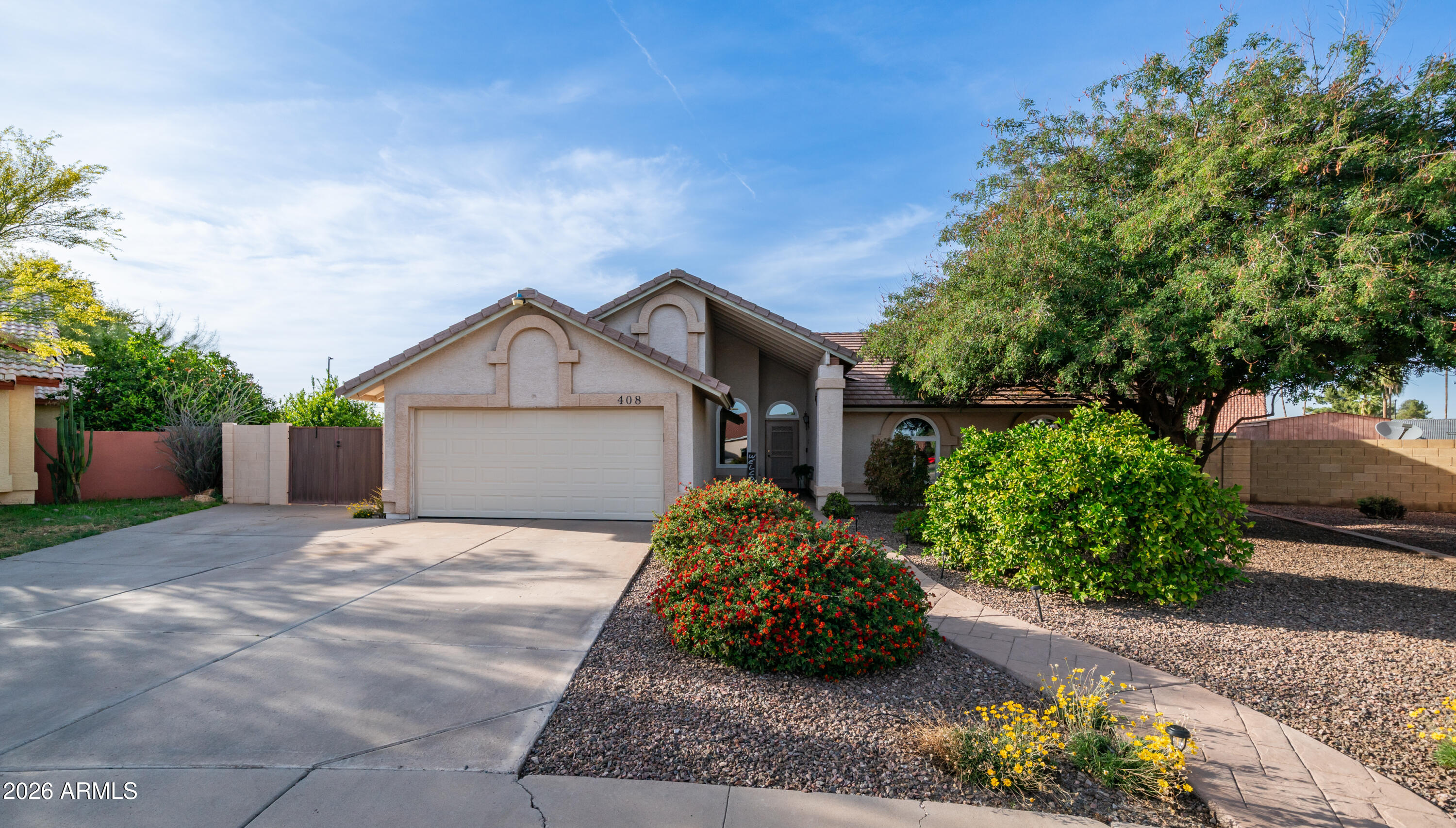 408 East Meadows Lane Gilbert, AZ 85234 - Photo 7 of 42 a front view of a house with a yard