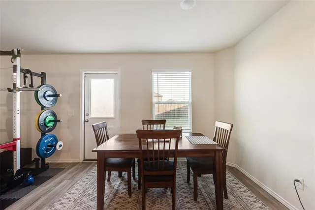 a view of a dining room with a table and chairs