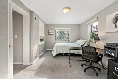 a bedroom with a bed and a desk