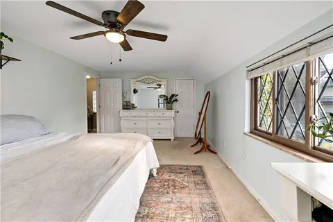a bedroom with a bed next to a window with the outer view
