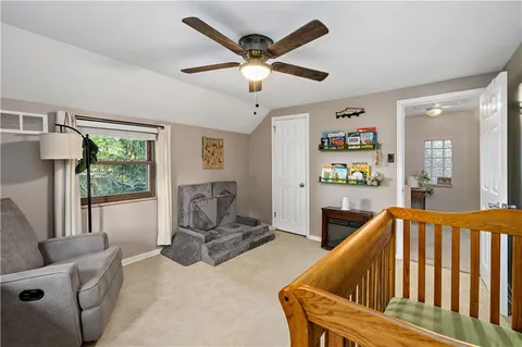 a living room with furniture and ceiling fan