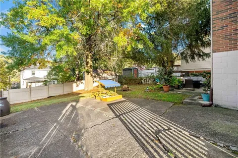 a view of a backyard with swimming pool