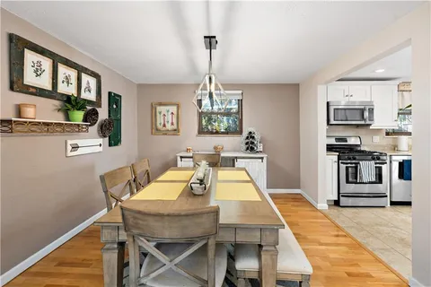 a dining room with furniture window and wooden floor