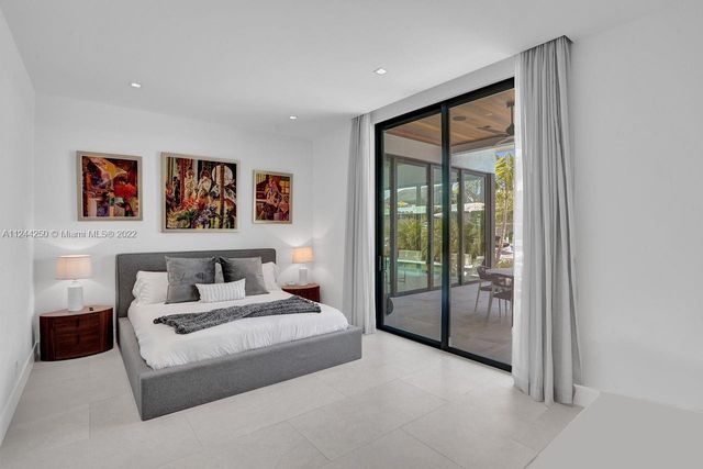 a spacious bedroom with a large bed and a painting on the wall