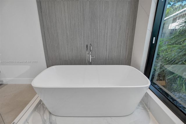 a white bath tub sitting in a bathroom