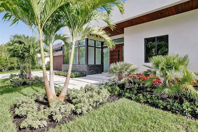 a view of a house with small yard and plants