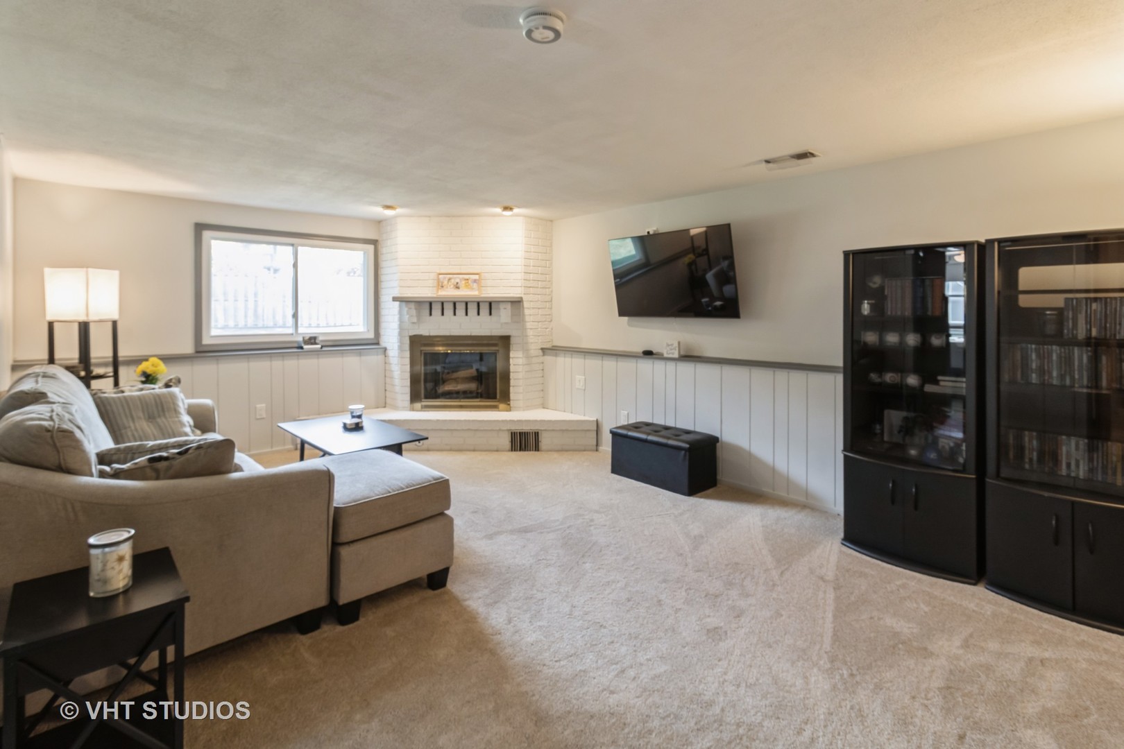 1942 Trail Ridge Street Arlington Heights, IL 60004 - Photo 11 of 29 a living room with furniture a flat screen tv and a fireplace
