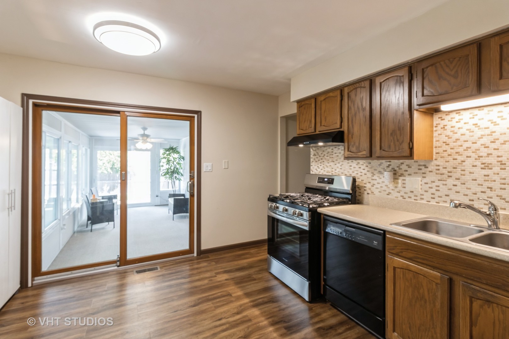 1942 Trail Ridge Street Arlington Heights, IL 60004 - Photo 6 of 29 a kitchen with stainless steel appliances granite countertop a sink stove and refrigerator