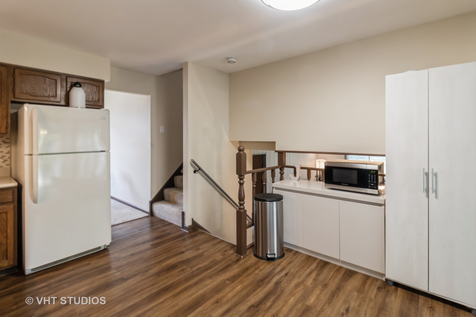 1942 Trail Ridge Street Arlington Heights, IL 60004 - Photo 7 of 29 a view of a kitchen with a refrigerator a stove top space and wooden floor
