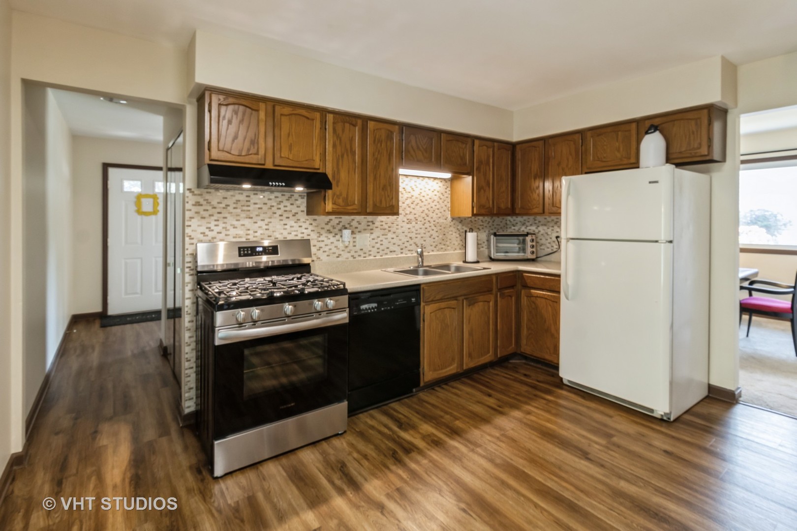 1942 Trail Ridge Street Arlington Heights, IL 60004 - Photo 8 of 29 a kitchen with a sink a refrigerator and cabinets