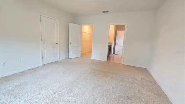 an empty room with windows and closet