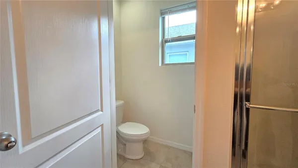 a bathroom with a toilet and a shower