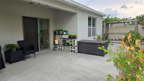 a view of backyard with outdoor seating and plants
