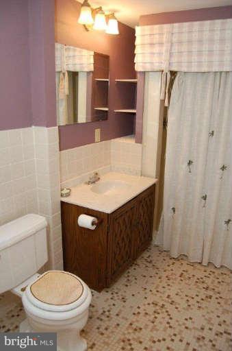 28 Cedar Knoll Road Cockeysville, MD 21030 - Photo 19 of 22 a bathroom with a sink a toilet and shower