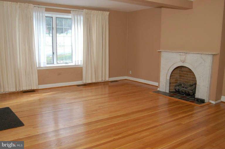 28 Cedar Knoll Road Cockeysville, MD 21030 - Photo 7 of 22 a view of an empty room with a window and wooden floor