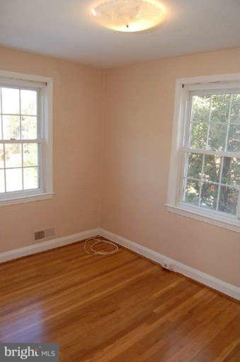 28 Cedar Knoll Road Cockeysville, MD 21030 - Photo 10 of 22 an empty room with wooden floor and windows