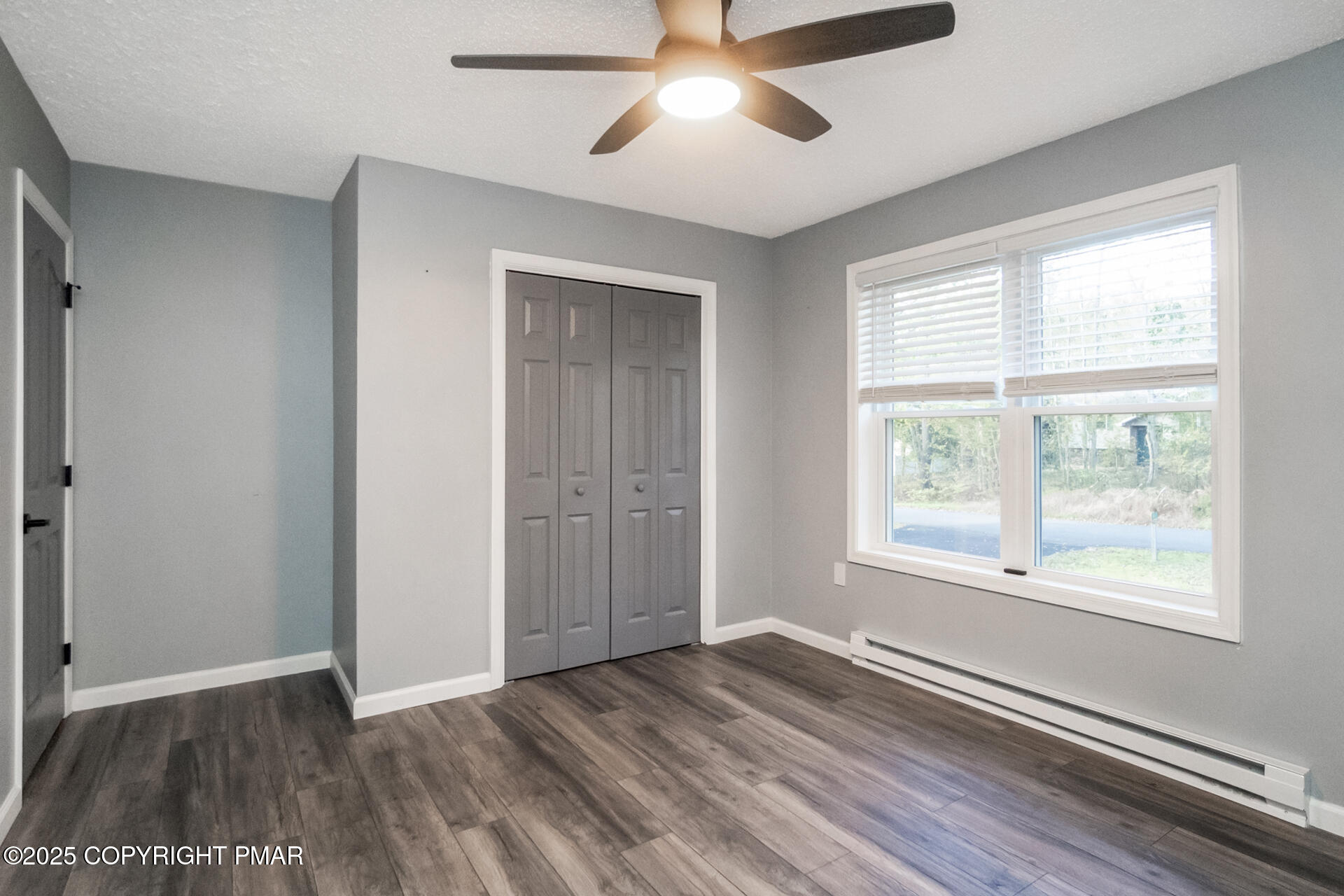 411 Alter Avenue Pocono Summit, PA 18346 - Photo 14 of 29 a view of an empty room with wooden floor and a window