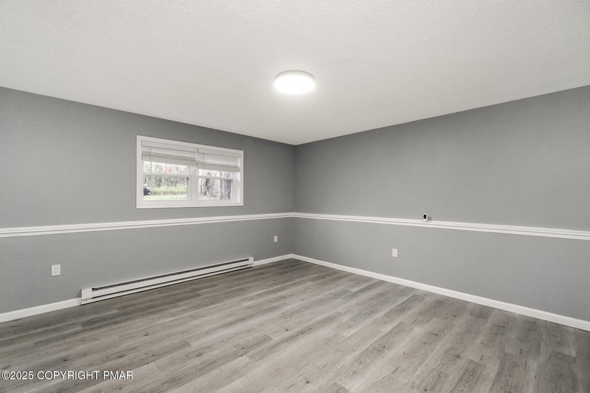 411 Alter Avenue Pocono Summit, PA 18346 - Photo 18 of 29 wooden floor in an empty room with a window