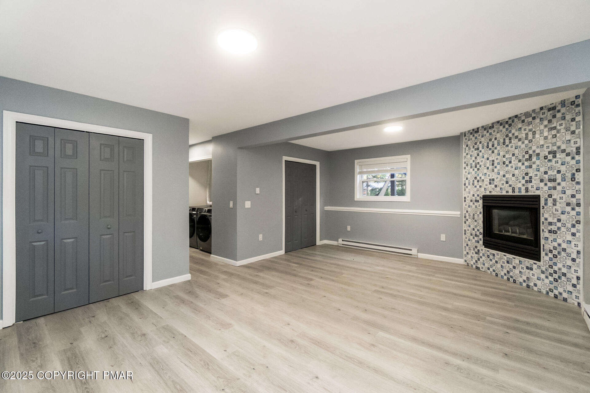 411 Alter Avenue Pocono Summit, PA 18346 - Photo 22 of 29 a view of an empty room with a fireplace and a window