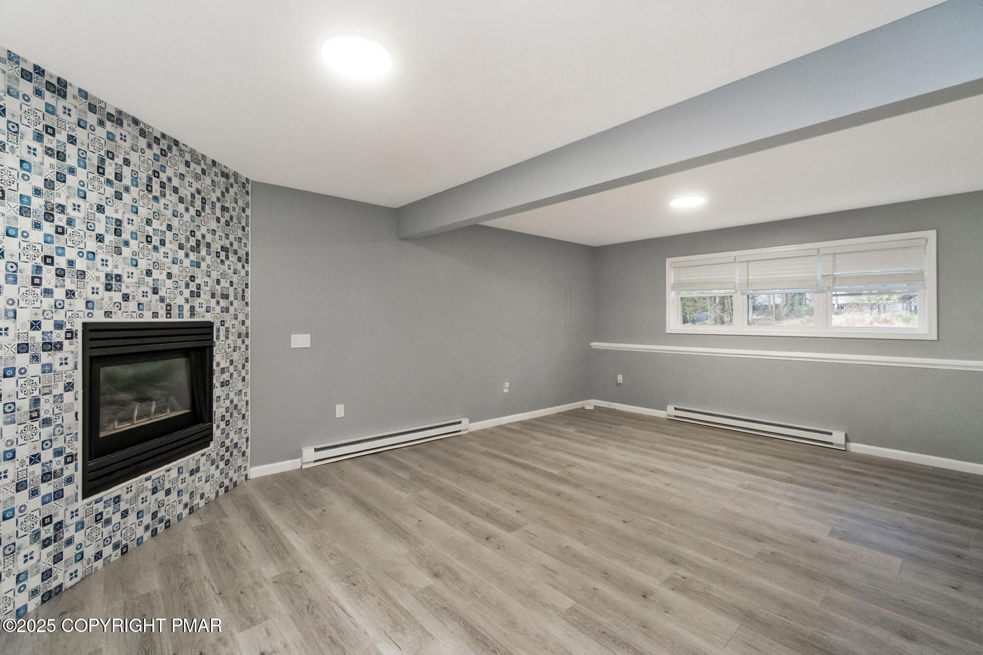 411 Alter Avenue Pocono Summit, PA 18346 - Photo 23 of 29 an empty room with windows and fireplace