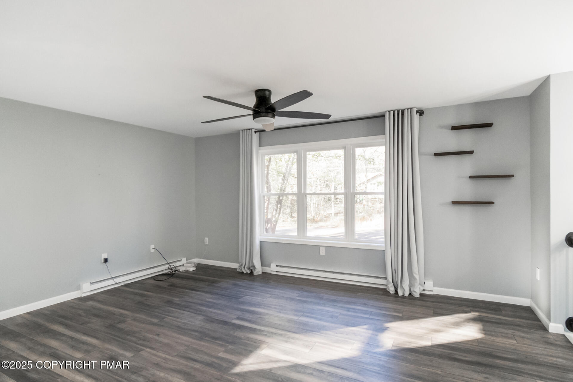 411 Alter Avenue Pocono Summit, PA 18346 - Photo 9 of 29 wooden floor in an empty room with a window