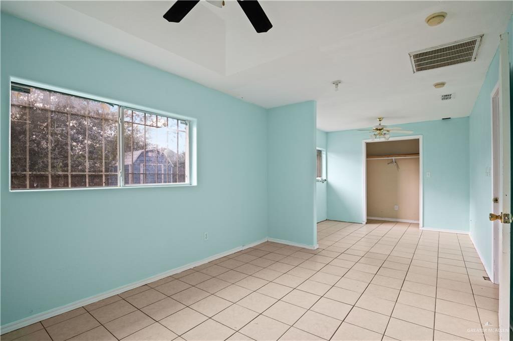 6402 South Mars Lane Pharr, TX 78577 - Photo 8 of 17 a bedroom with a bed and a window