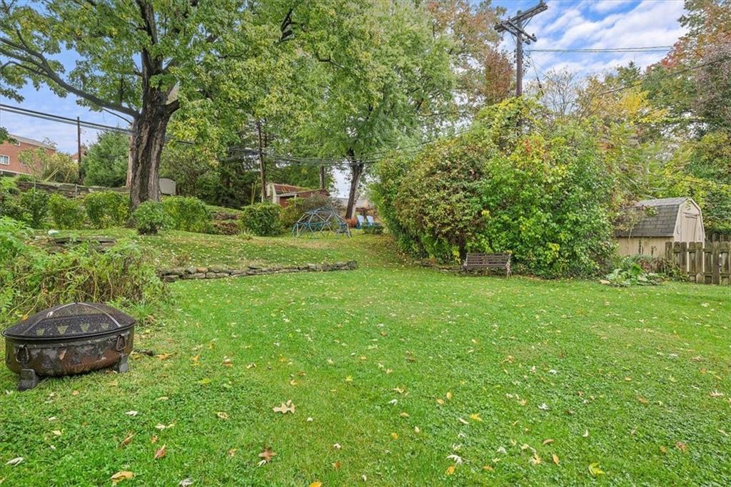 2026 Brookfield Road Pittsburgh, PA 15243 - Photo 24 of 25 a view of a backyard with table and chairs and large trees