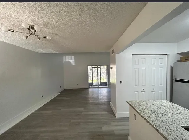 a view of bathroom with bathtub and wooden floor