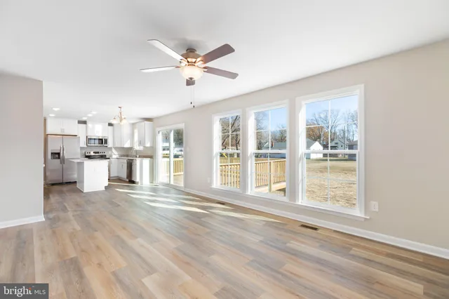 a view of a kitchen with wooden floor and a window