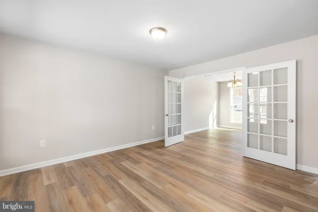 wooden floor in an empty room with a window
