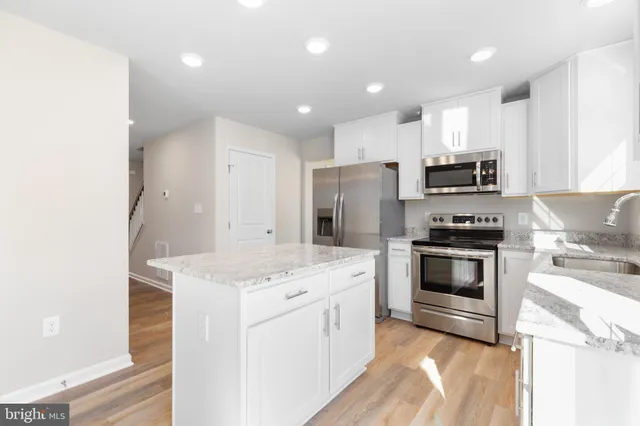 a kitchen with a sink stove and refrigerator