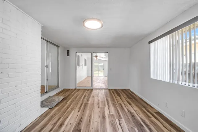 a view of a room with wooden floor and windows
