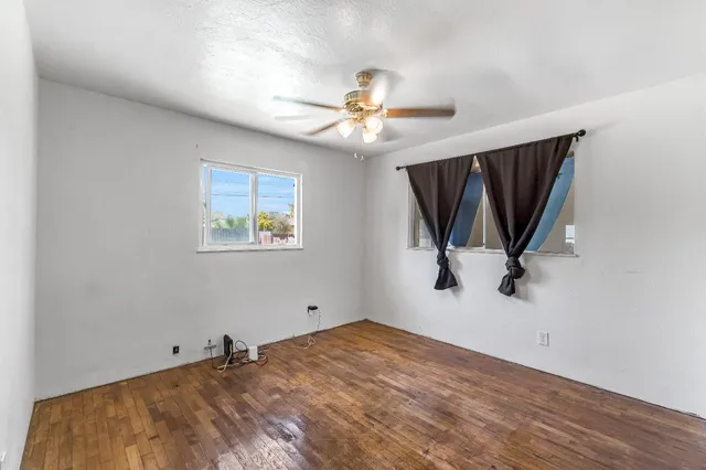a view of a room with window and a ceiling fan
