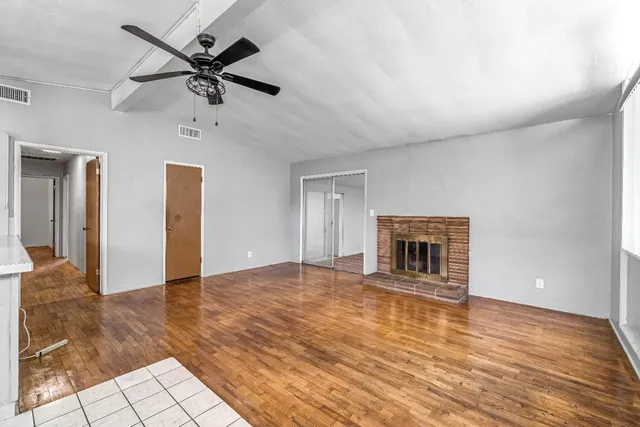 a view of a livingroom with a ceiling fan and window