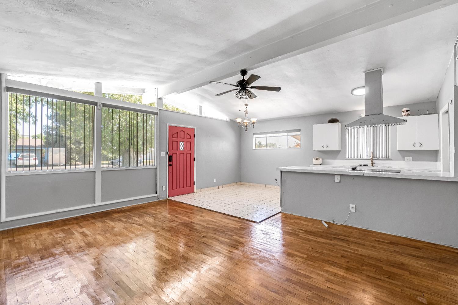 835 I Street Parlier, CA 93648 - Photo 7 of 27 a view of a kitchen with wooden floor and a window
