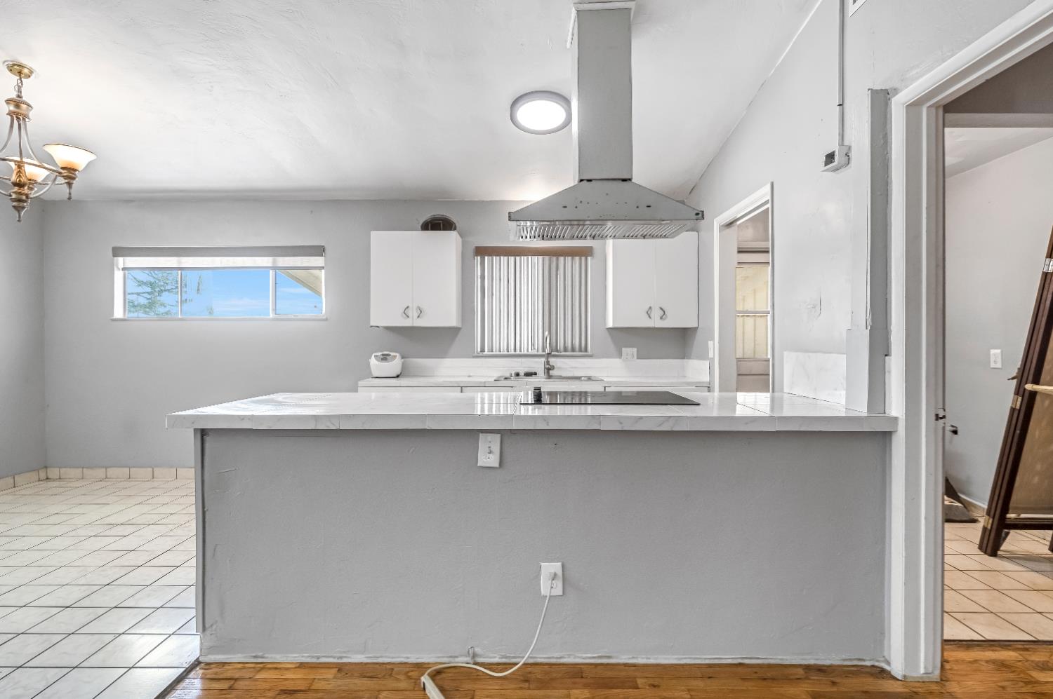 835 I Street Parlier, CA 93648 - Photo 9 of 27 a kitchen with stainless steel appliances a sink cabinets and wooden floor