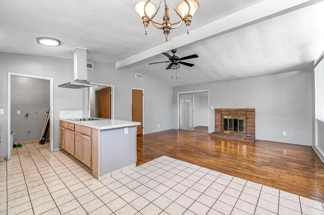 a kitchen with stainless steel appliances a stove top oven and cabinets