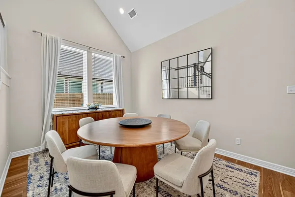 a dining room with furniture and wooden floor
