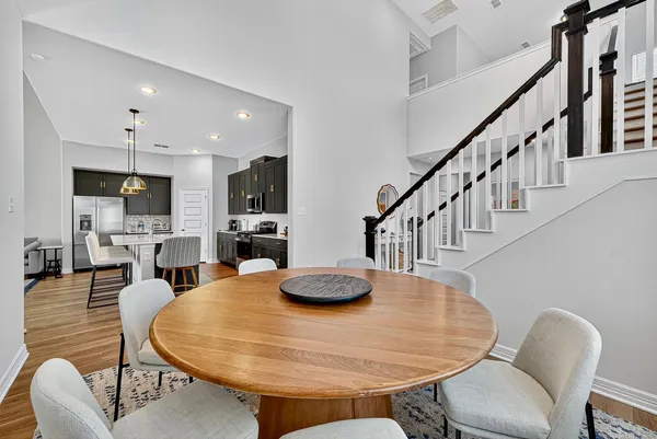 a dining room with furniture and wooden floor