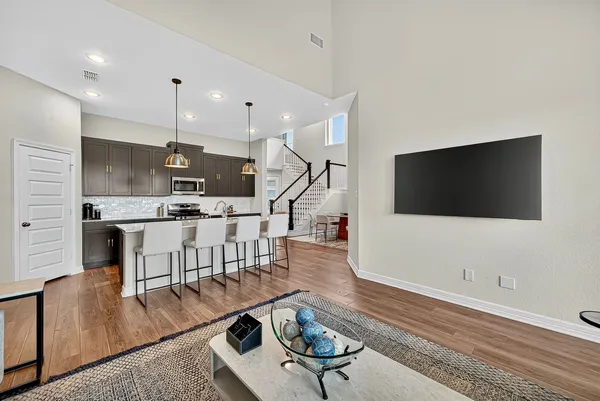 a living room with furniture and wooden floor