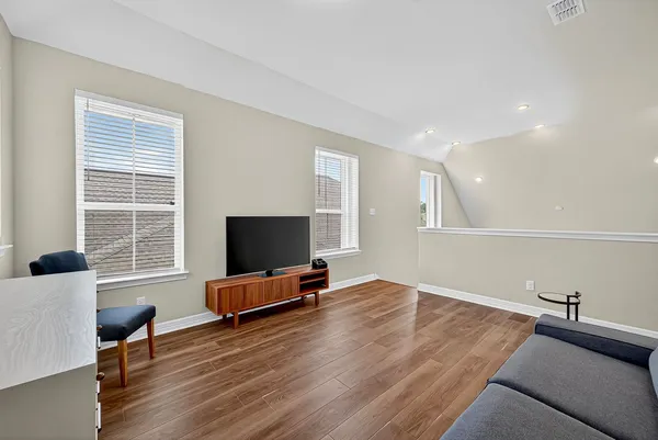 a living room with a couch and a wooden floor
