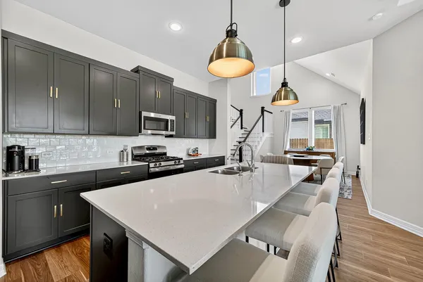a dining room with furniture and wooden floor