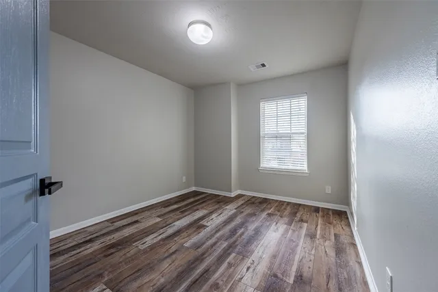 a view of room with window and hardwood floor