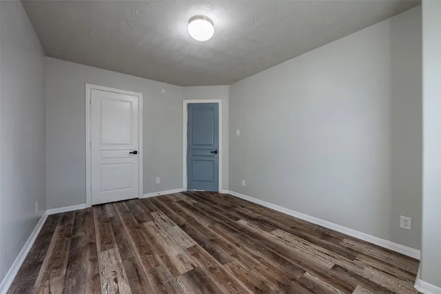 a view of a room with wooden floor