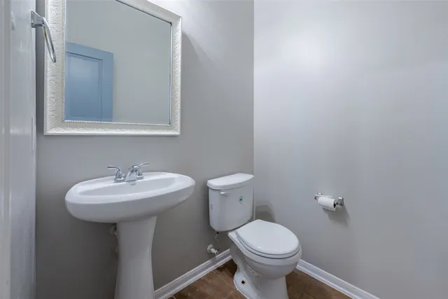 a bathroom with a sink toilet and a mirror