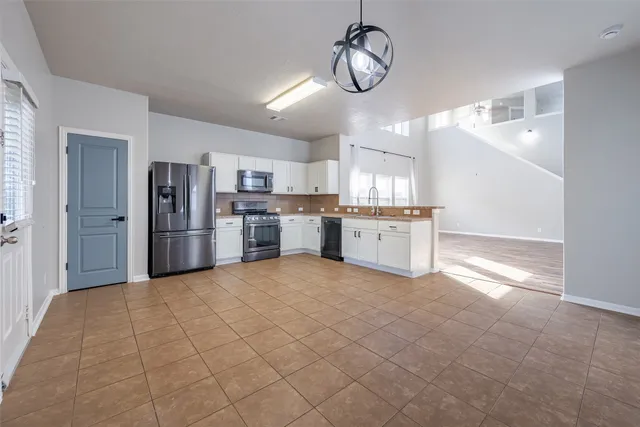 a large kitchen with cabinets and stainless steel appliances