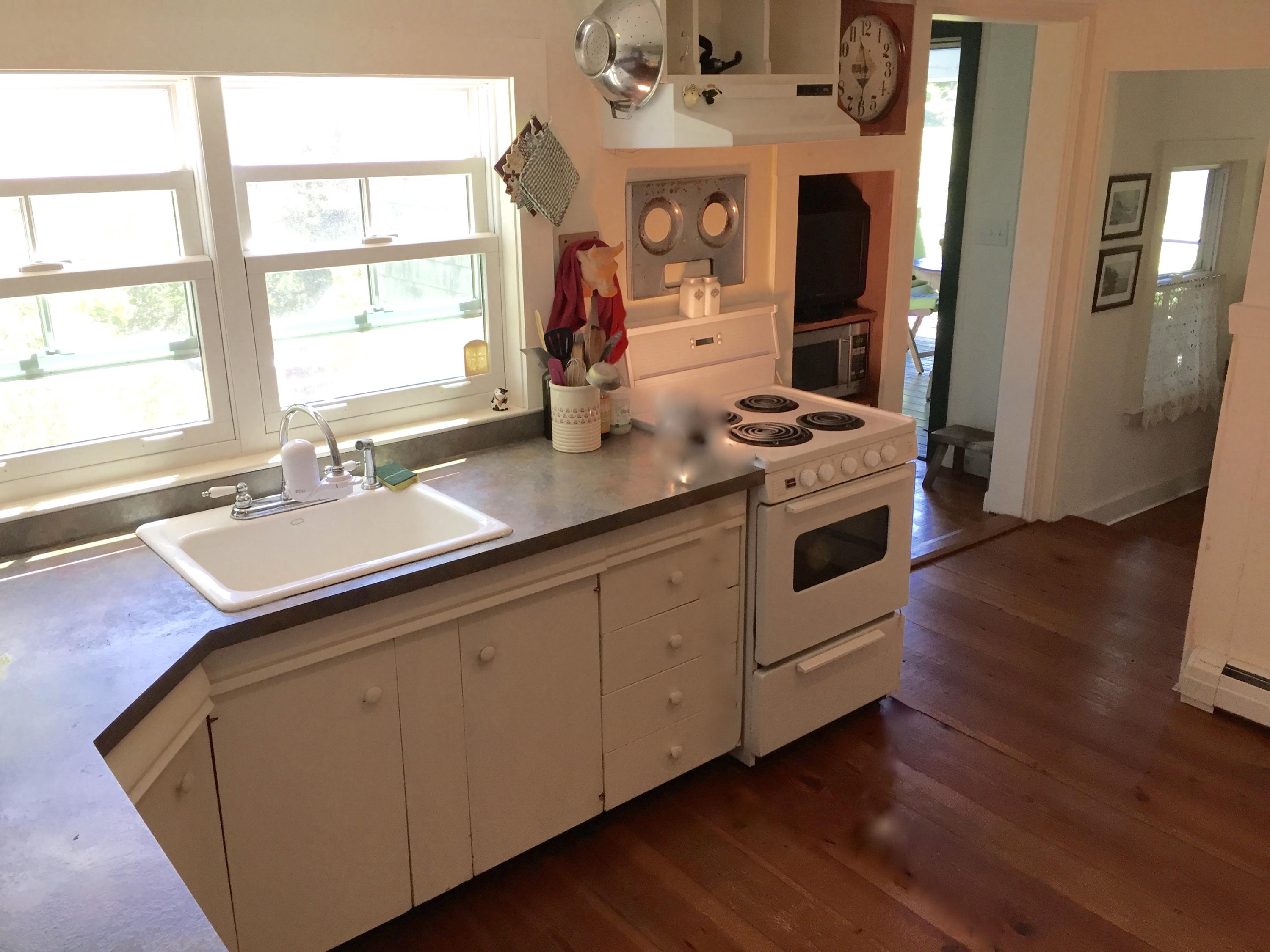 9 Francis Road Truro, MA 02666 - Photo 12 of 34 a kitchen with stainless steel appliances granite countertop a sink stove and wooden floor