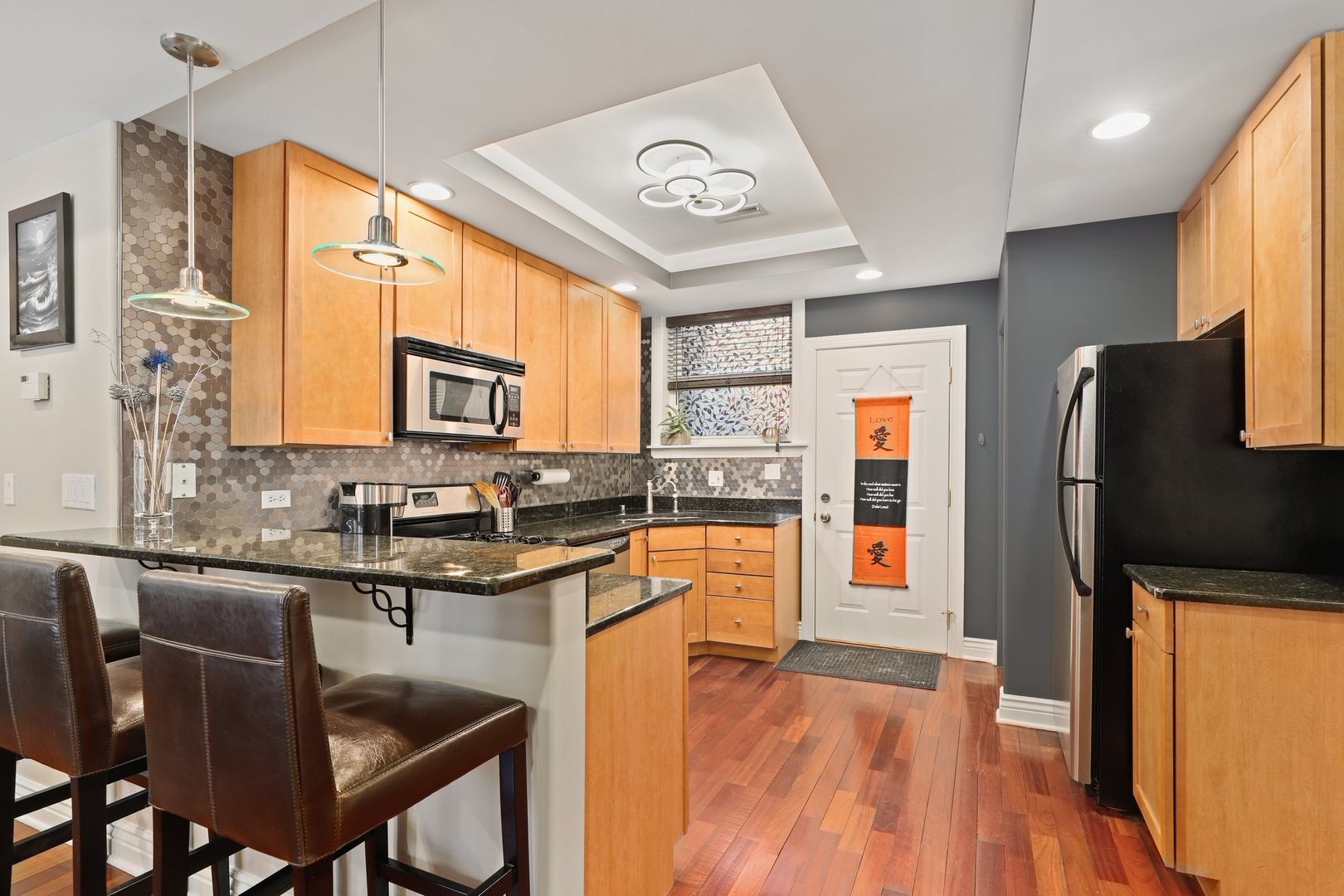 528 West Cornelia Avenue, Unit 2N Chicago, IL 60657 - Photo 16 of 19 a kitchen with stainless steel appliances granite countertop a sink stove and refrigerator